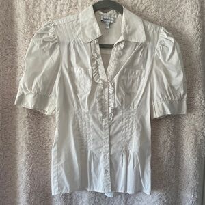 White short sleeve ruffle front blouse.  Size medium, brand Bebe.  Like new.